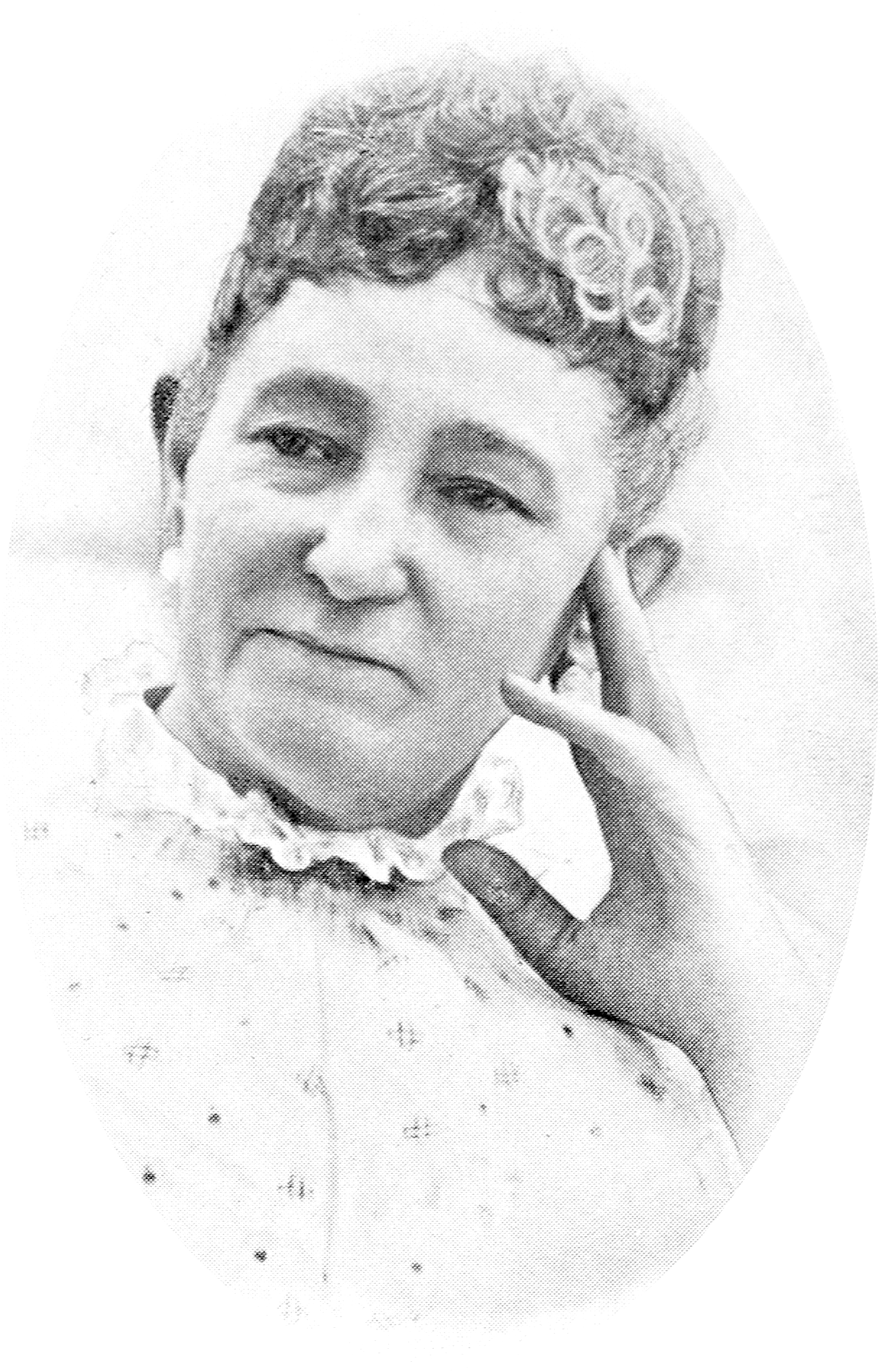Sara Weiss, a middle-aged woman with slightly curly hair, with her hand resting against her face.